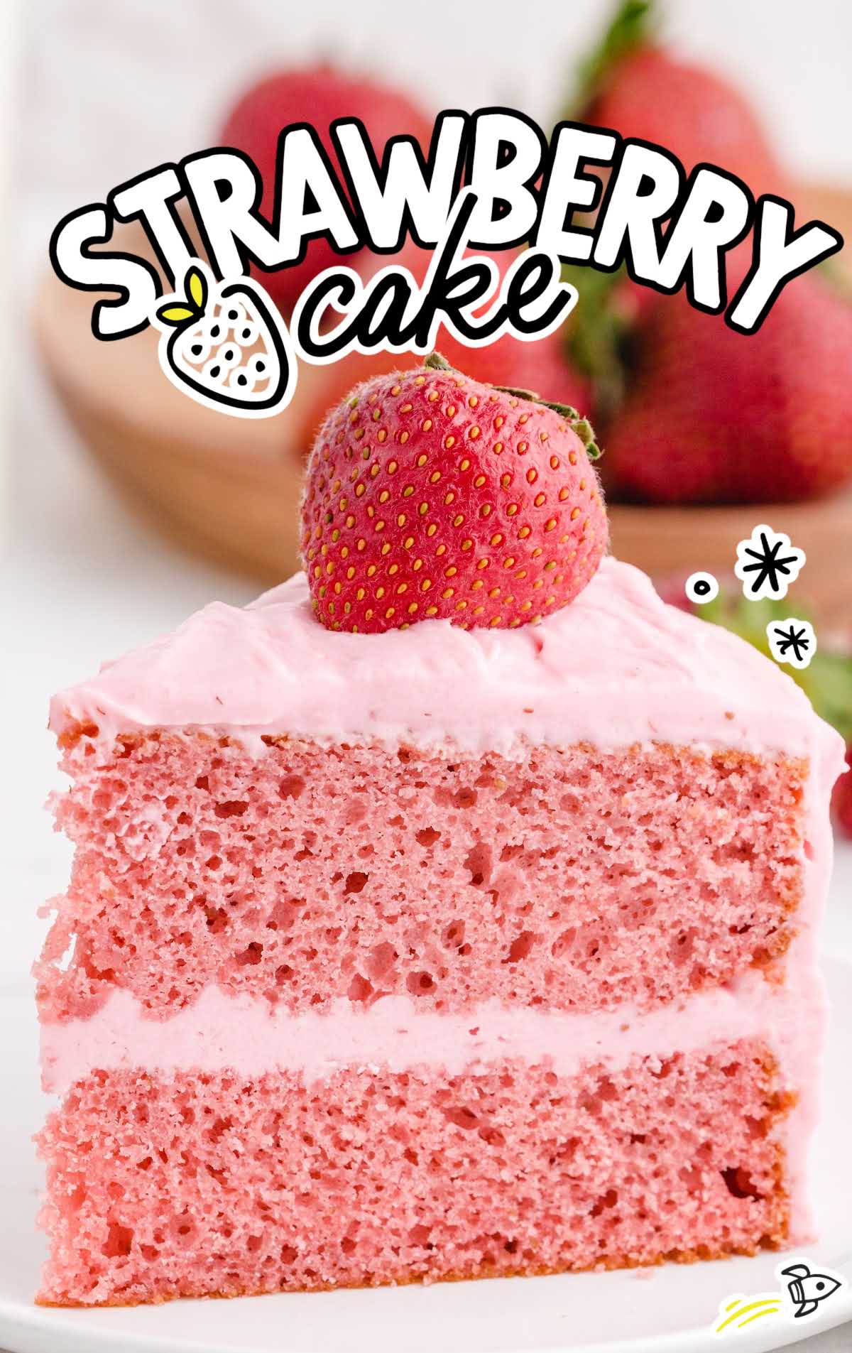 a slice of strawberry cake with a strawberry on top on a plate
