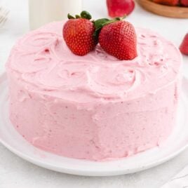 a strawberry cake with strawberries on top on a plate