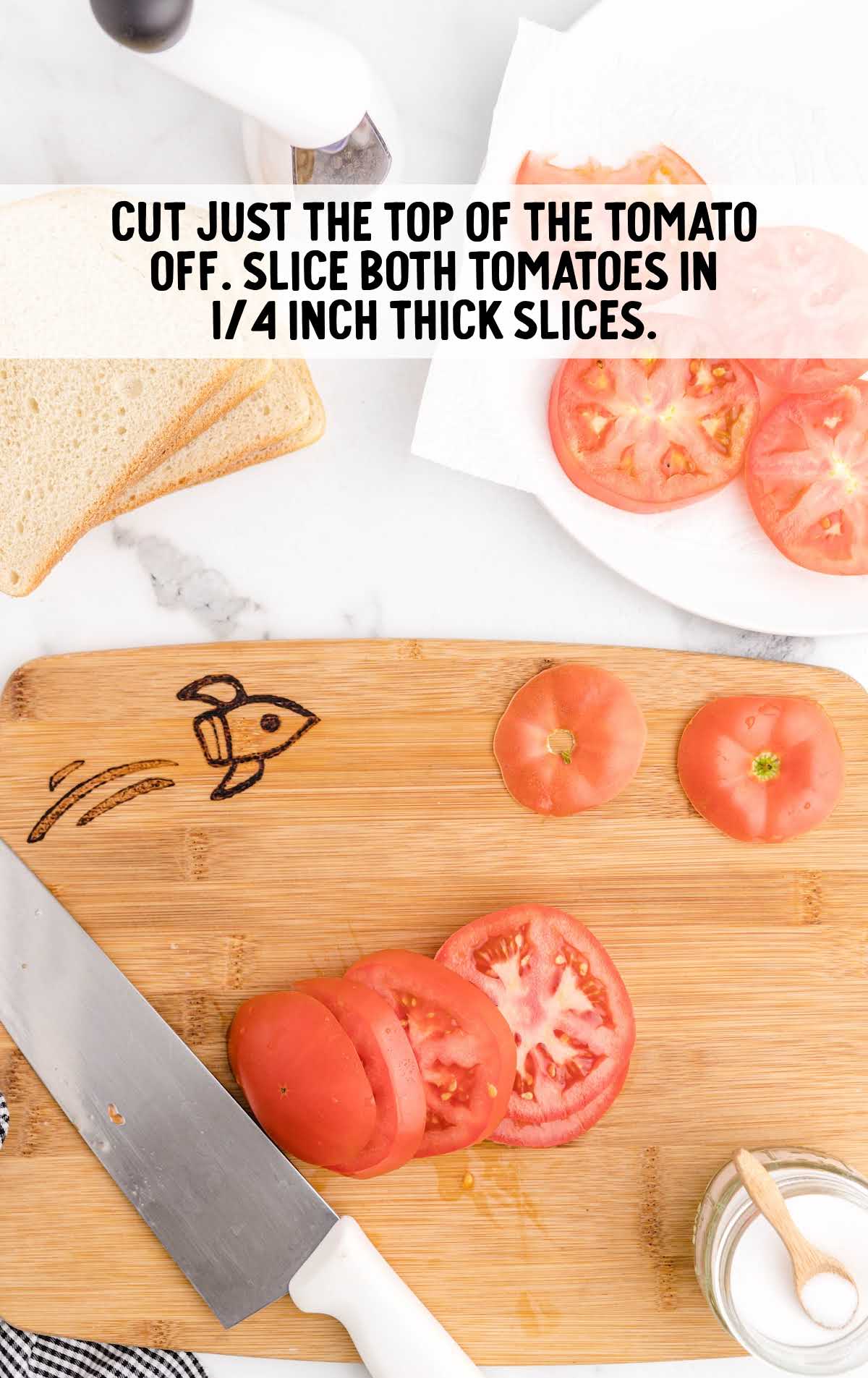 tomato sandwich process shot of tomatoes being sliced on a wooden board