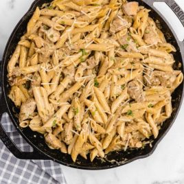 close up overhead shot of creamy chicken pasta in a pan