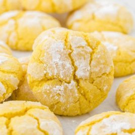 close up shot of lemon crinkle cookies on a cookie sheet