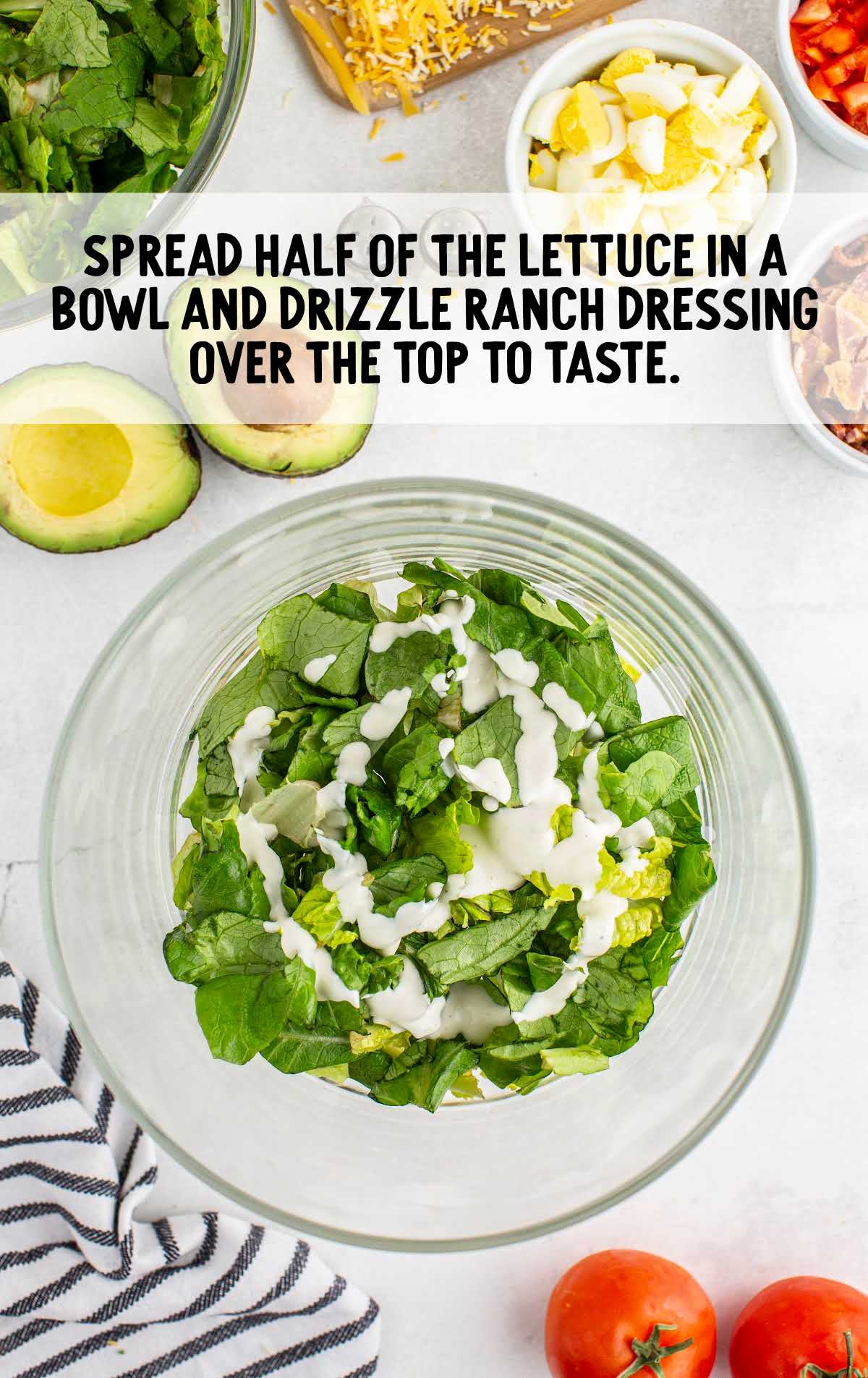ranch dressing being poured over lettuce in a bowl