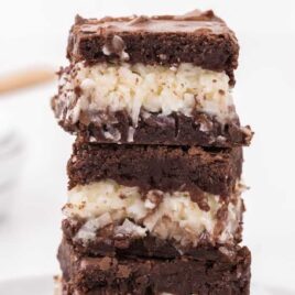 close up shot of Coconut Brownies stacked on top of each other