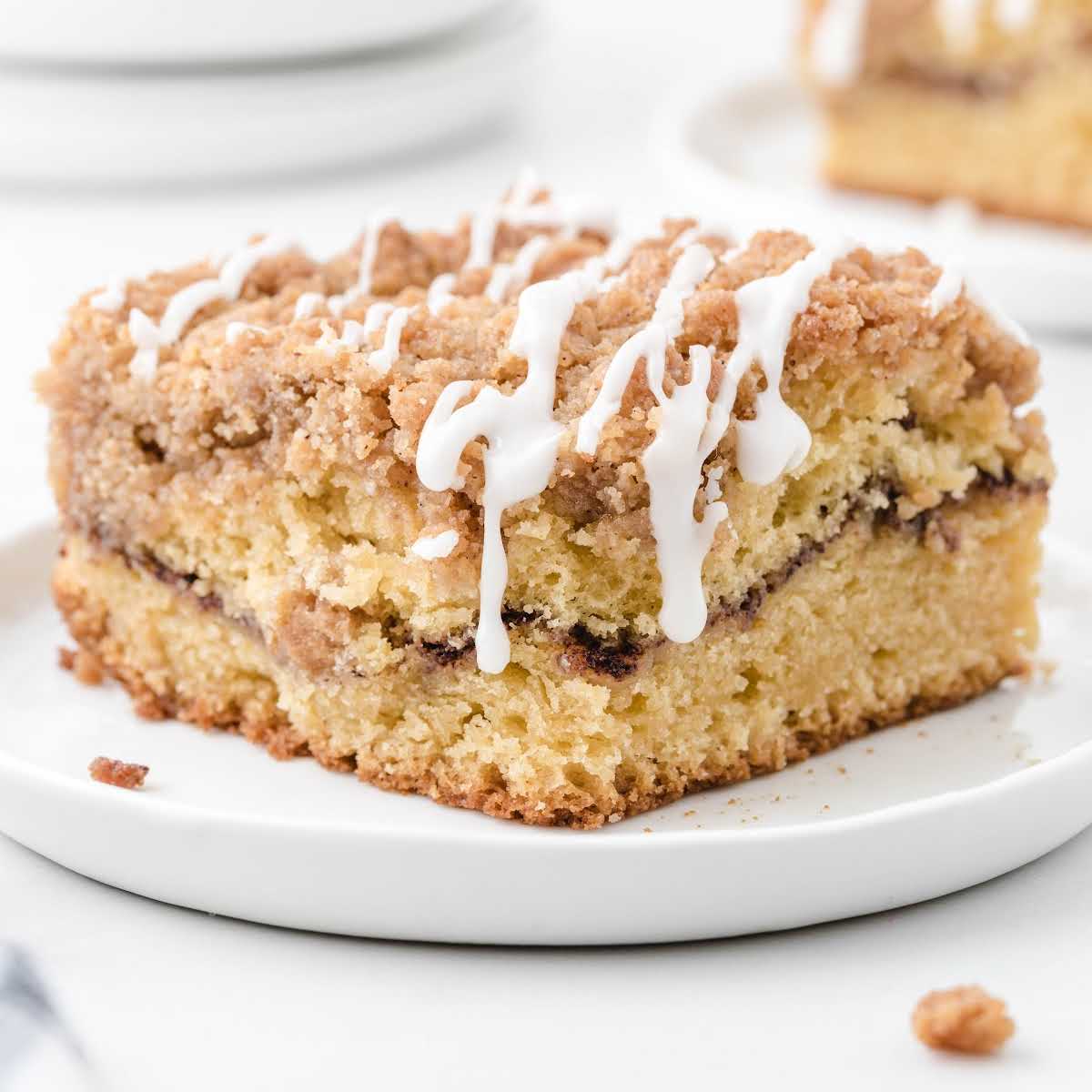 Slice of cinnamon coffee cake on white plate, perfect for breakfast or dessert