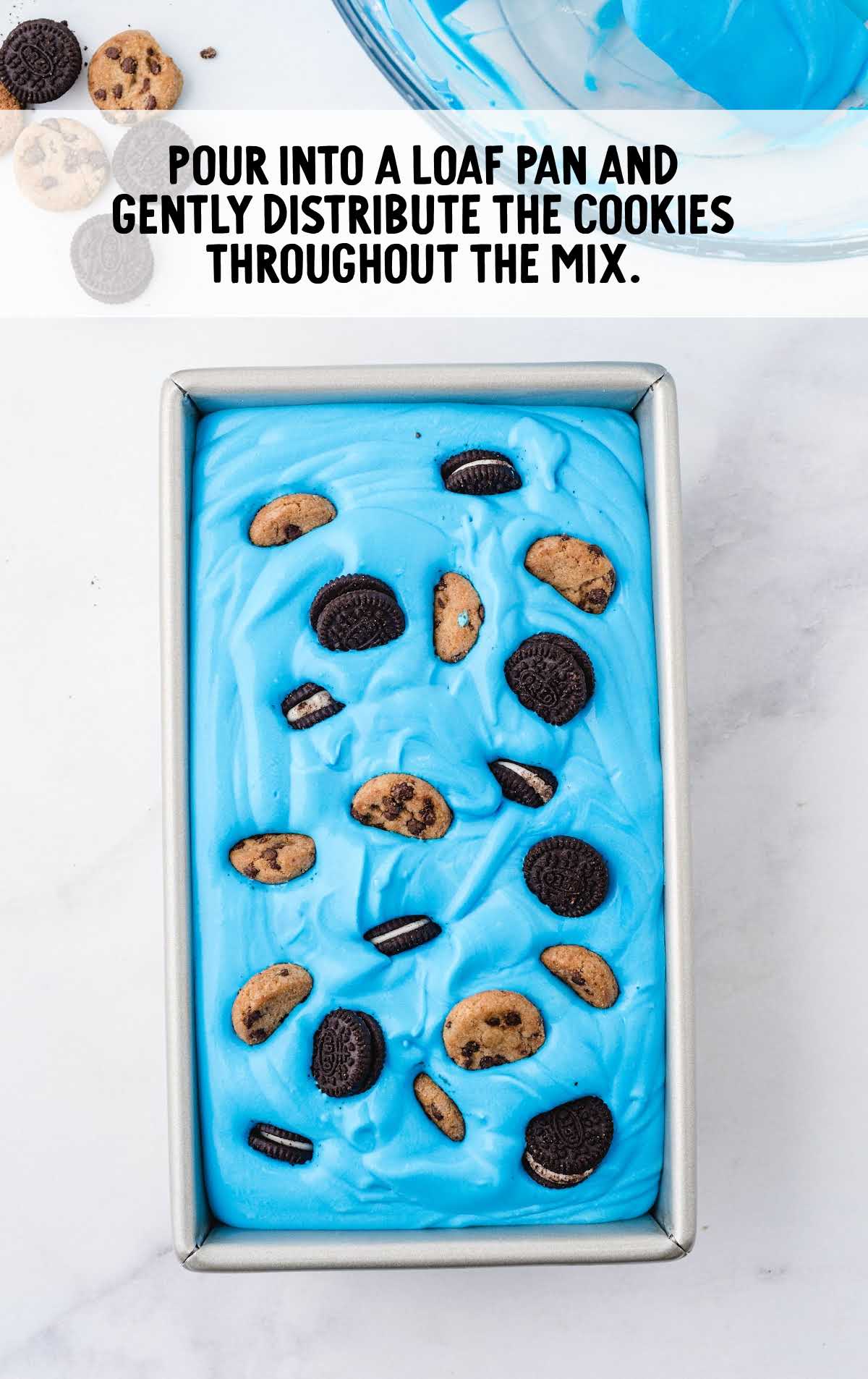 ice cream in a loaf pan being topped with cookies