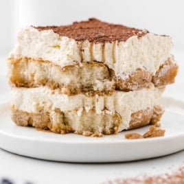 Square image of tiramisu slice with soft creamy layers and cocoa dusting, ideal for recipe card usage