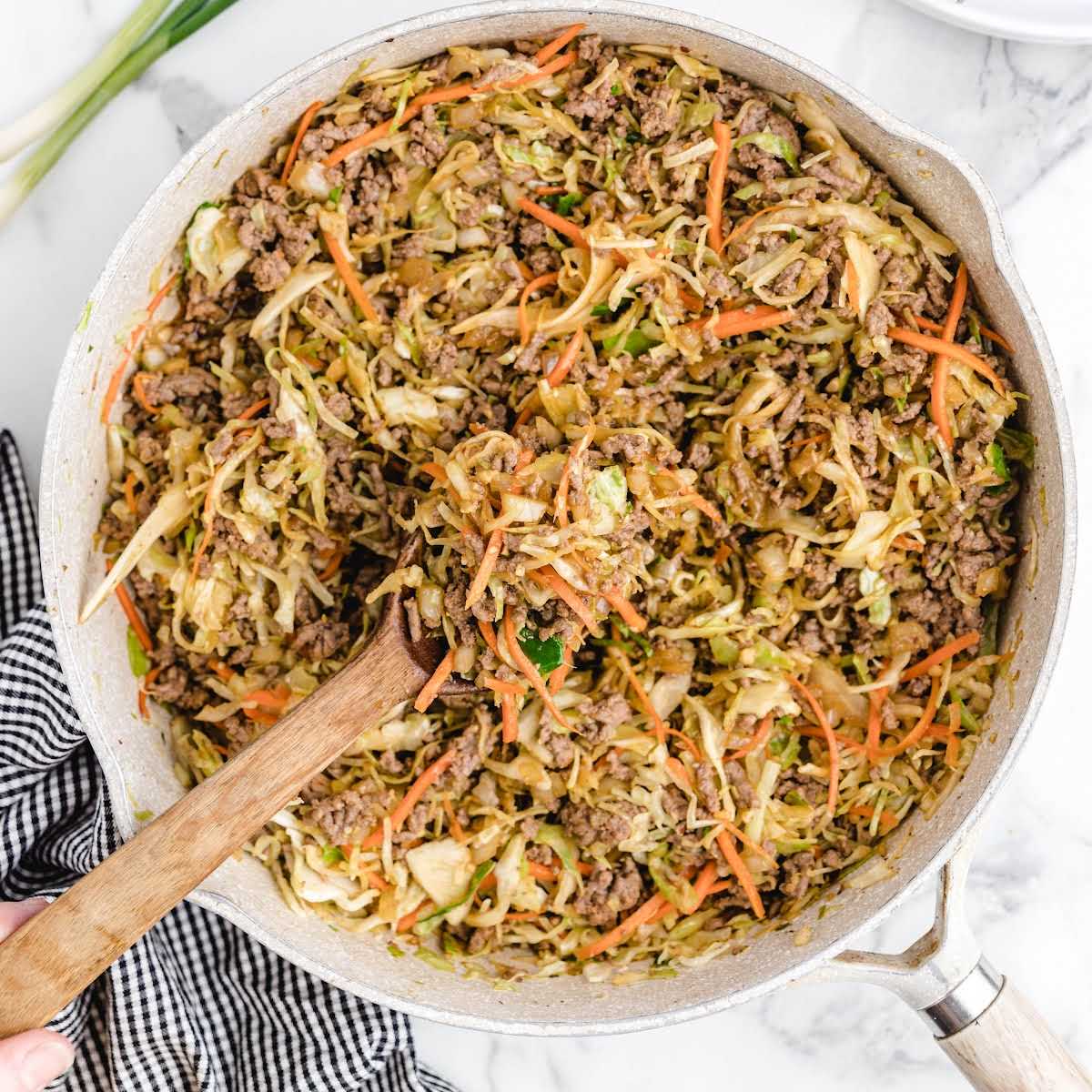 close up overhead shot of Egg Roll mixture in a skillet with a spoon