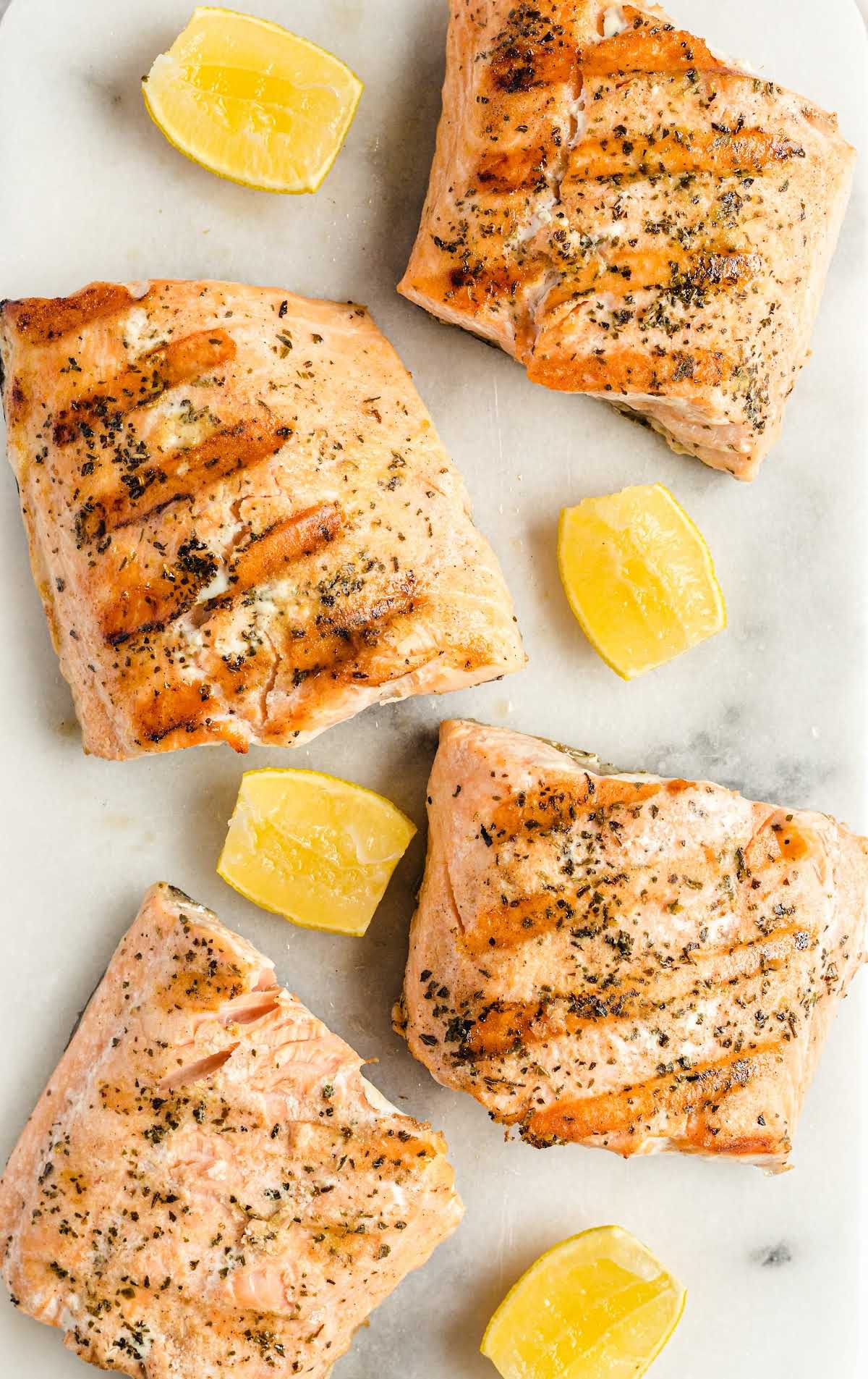 close up overhead shot of slices of grilled salmon with slices of lemon
