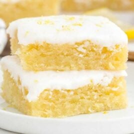 close up shot of Lemon Brownies stacked on top of each other on a plate