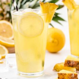 glasses of pineapple lemonade with ice and lemon slices