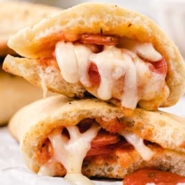 Homemade pizza pockets filled with melted mozzarella cheese and pepperoni served with marinara sauce.