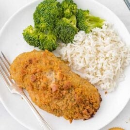 close up overhead shot of a plate of Ritz Cracker Chicken served with white rice and broccoli