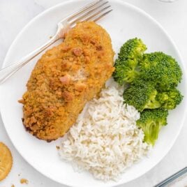 close up overhead shot of a plate of Ritz Cracker Chicken served with white rice and broccoli