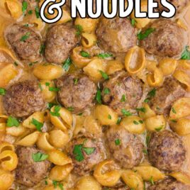 swedish meatballs and noodles garnished with parsley in a baking dish