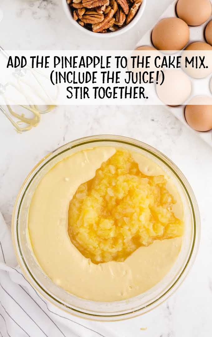 crushed pineapples added to the cake mix in a bowl