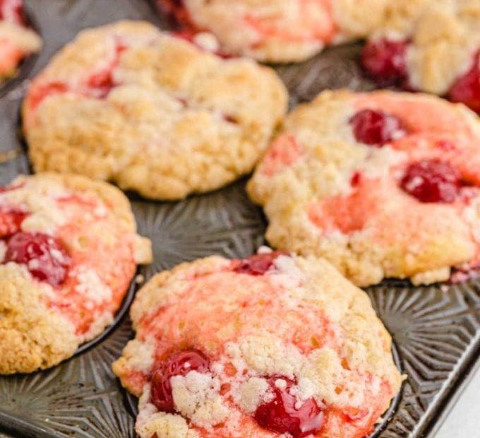 close up shot of cherry cobbler muffins in a muffin pan