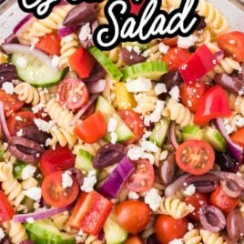 a bowl of greek salad topped with feta cheese