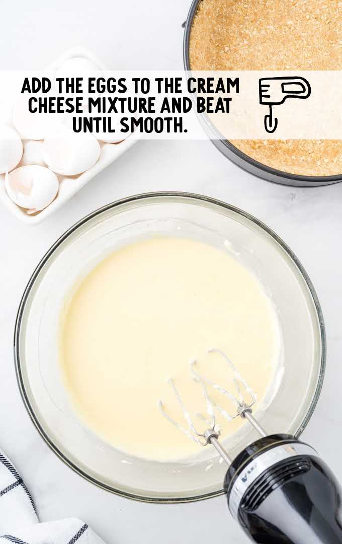 eggs and cream cheese being blended into a bowl