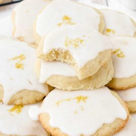 close up shot of lemon meltaway cookies piled on top of each other on a plate