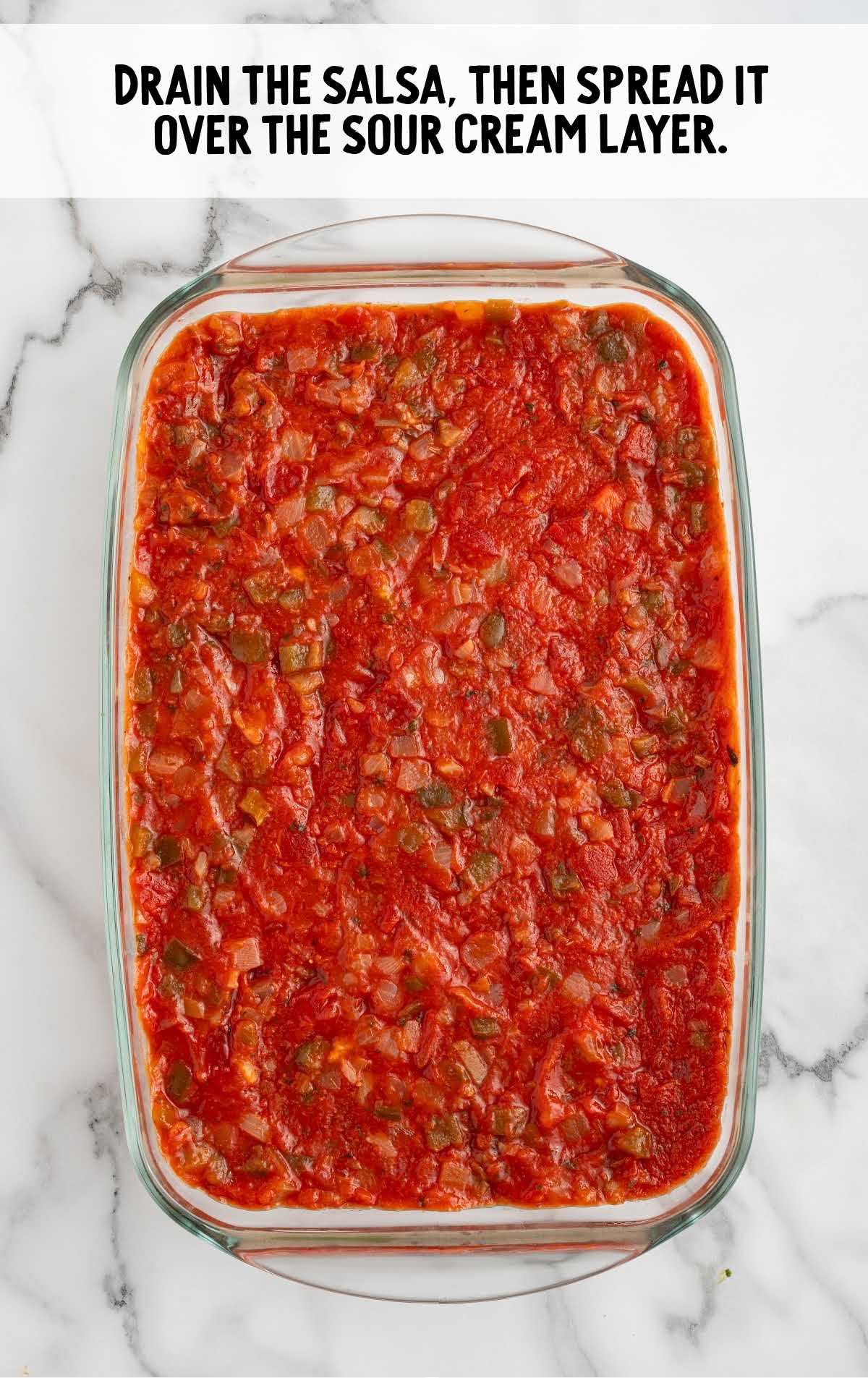 salsa spread over the sour cream layer