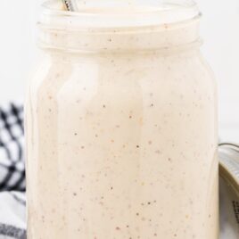Alabama White Sauce in a jar with a spoon