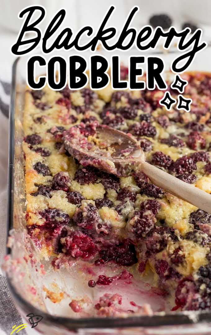 close up shot of blackberry cobbler in a baking dish with a wooden spoon and a serving missing