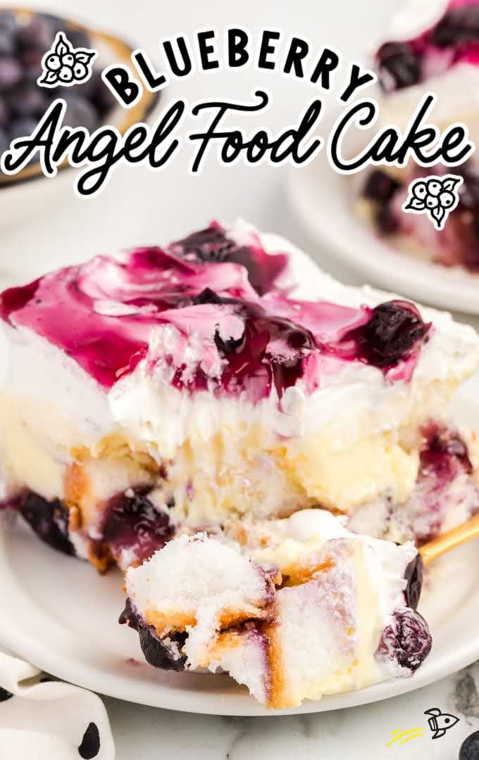 close up shot of a slice of blueberry angel food cake with a piece being taken out with a fork on a plate