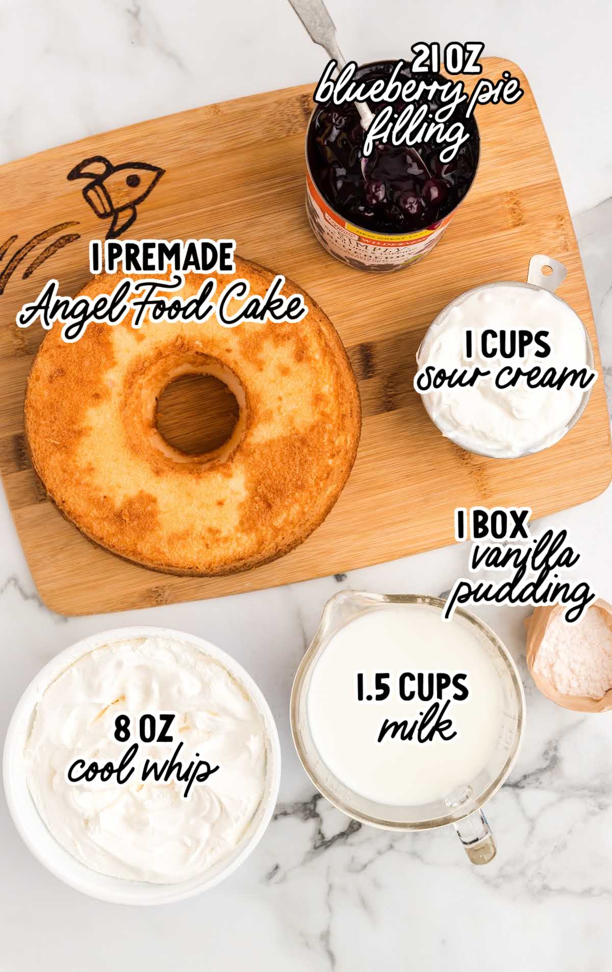 Labeled ingredients for blueberry angel food cake including premade angel food cake, blueberry pie filling, cool whip, sour cream, vanilla pudding, and milk.