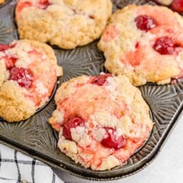 close up shot of cherry cobbler muffins in a muffin pan