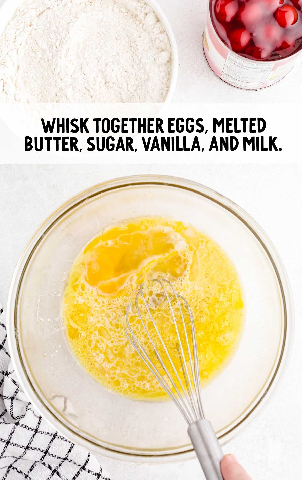 eggs, butter, sugar, vanilla extract, and milk whisked into a bowl