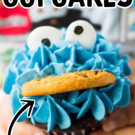 close up shot of Cookie Monster Cupcakes with candy eyes and a cookie being held
