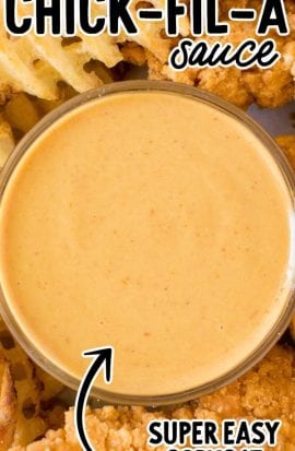 close up overhead shot of copycat chick fil a sauce in a condiment cup with chicken tenders and fries
