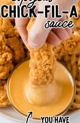 close up shot of copycat chick fil a sauce in a condiment cup with chicken tenders and fries