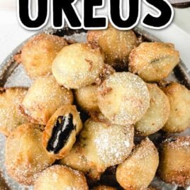 close up overhead shot of deep fried oreos sprinkled with powdered sugar on a plate