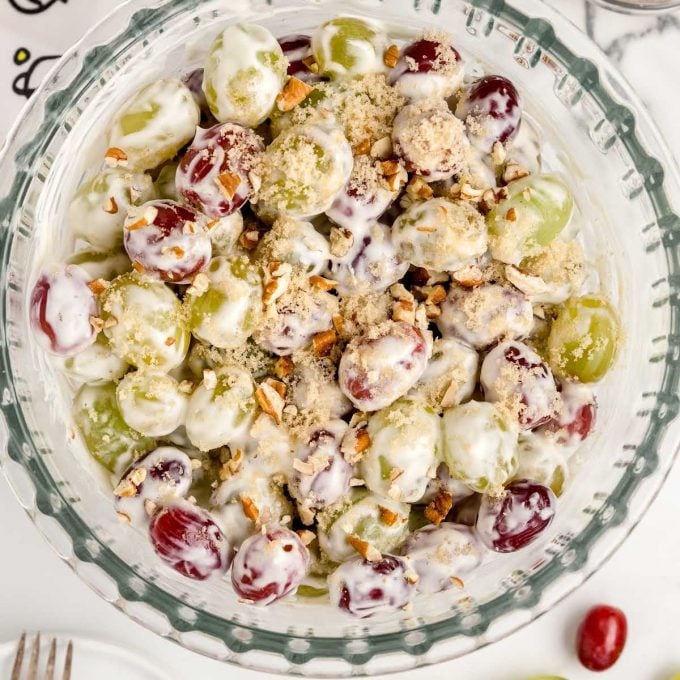 close up overhead shot of a bowl of Grape Salad garnished with chopped pecans
