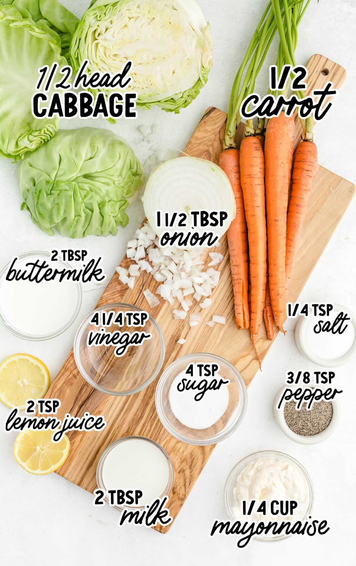 Flat lay of ingredients for KFC copycat coleslaw including cabbage, carrots, onion, buttermilk, mayonnaise, and seasonings on a wooden board.