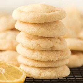 close up shot of Lemon Sugar Cookies stacked on top of each other on a cooling rack
