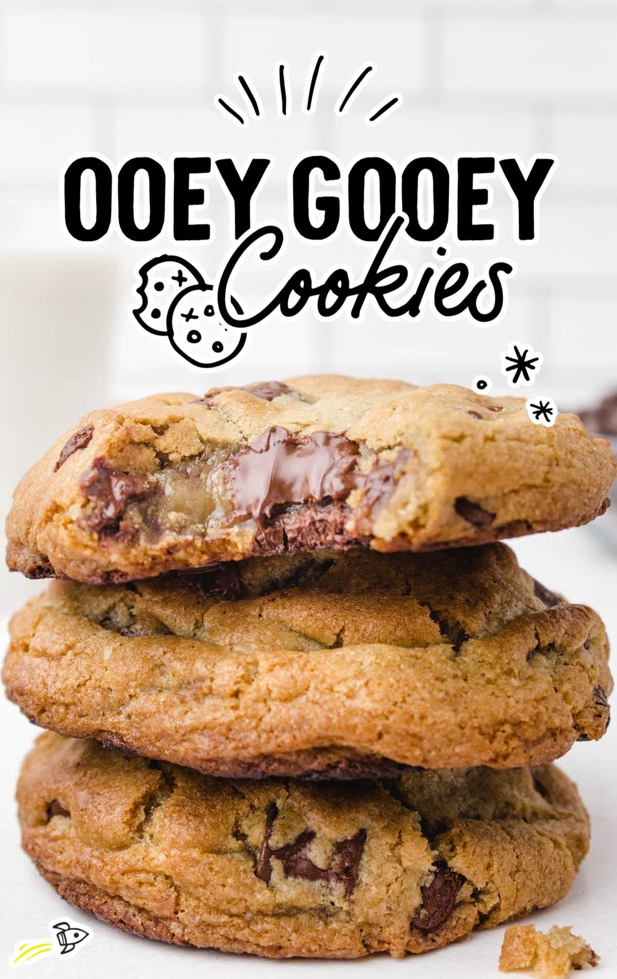 Thick and chewy chocolate chip cookies stacked with gooey melted chocolate spilling from the center.