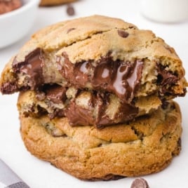 Close-up of a broken cookie stacked on another, revealing a melty chocolate center.