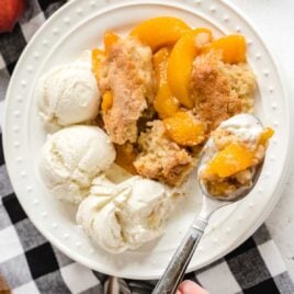 a plate of peach cobbler with vanilla ice cream