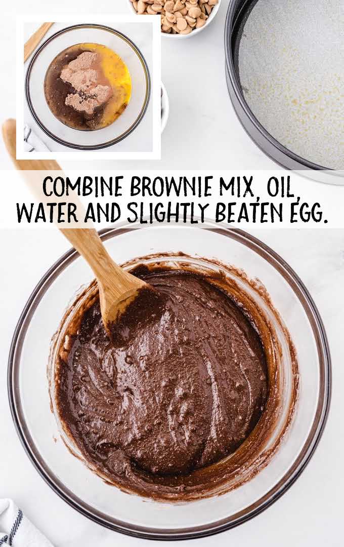 brownie mix, oil, water, and beaten egg being mixed together in a bowl with a large wooden spoon