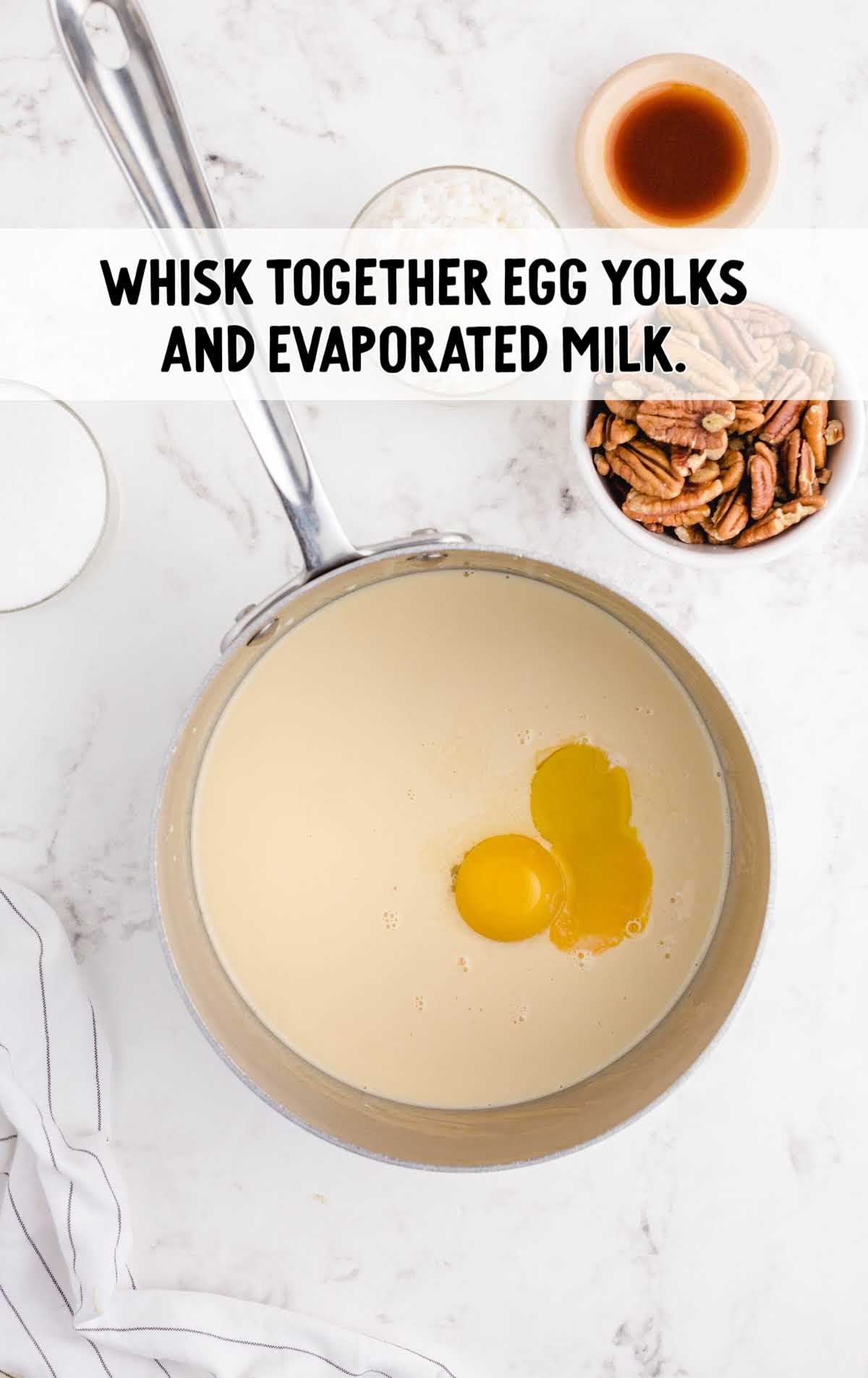 egg yolks and evaporated milk whisked together in a pot 