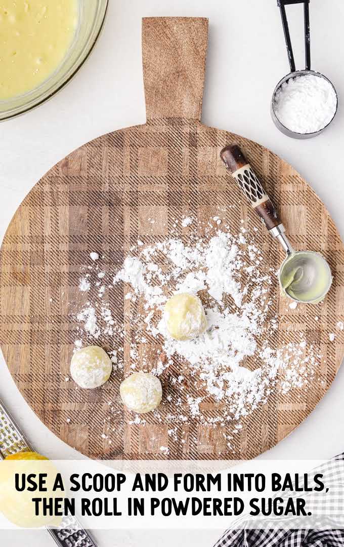 white chocolate lemon truffles process shot of balls being rolled into powdered sugar