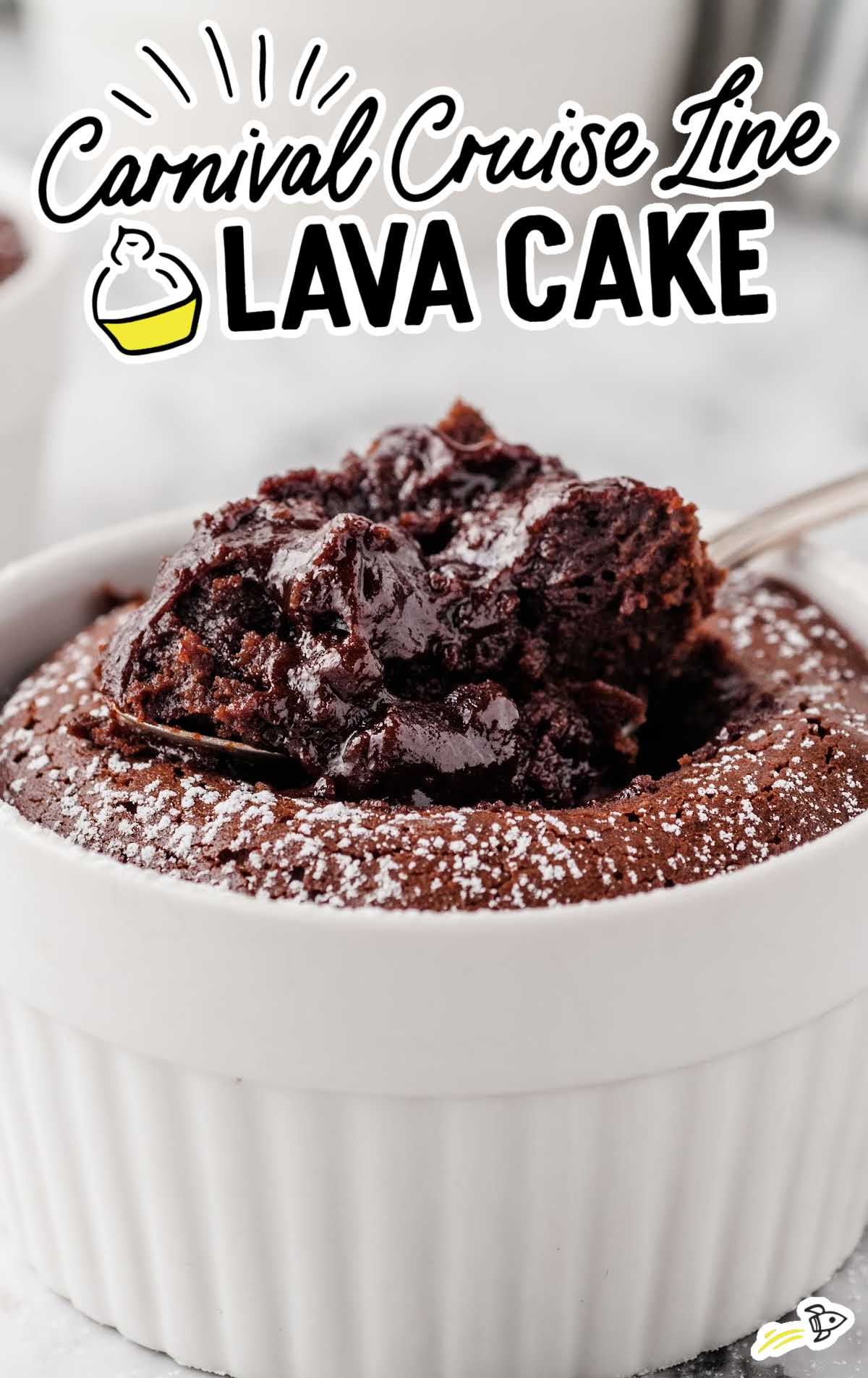 World Famous Carnival Cruise Line lava cake with a spoonful of molten chocolate center, served in a white ramekin.