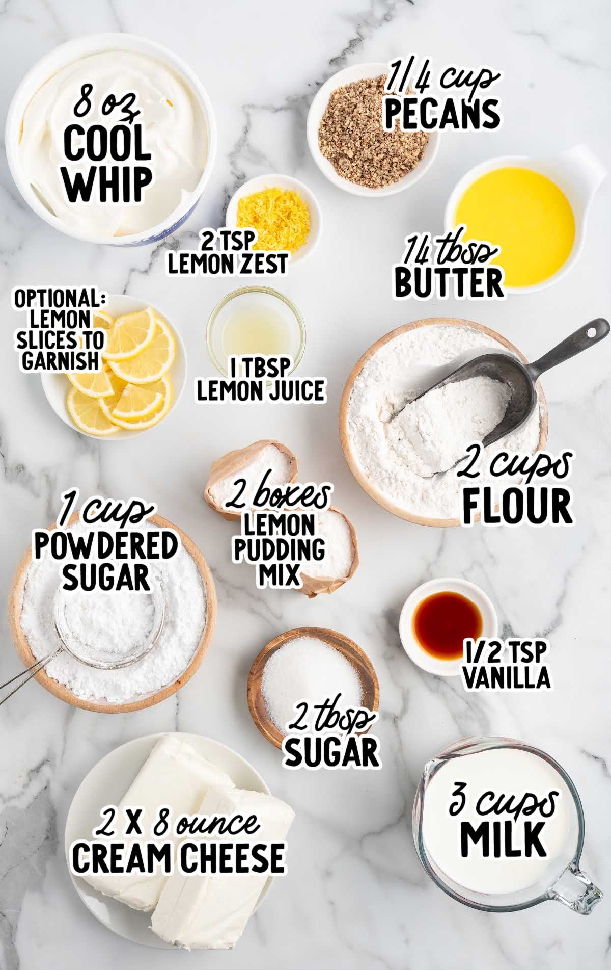 Overhead view of labeled lemon lush ingredients including cream cheese, Cool Whip, lemon pudding mix, pecans, butter, flour, and lemon zest on a marble background.