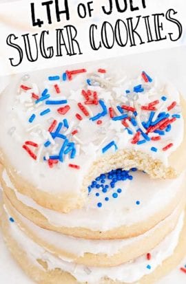 close up shot of 4th of July sugar cookies topped with frosting and sprinkles stacked on top of each other