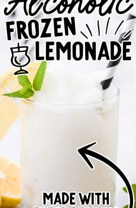 close up shot of alcoholic frozen lemonade in a clear glass with a slice of lemon and mint served with a straw