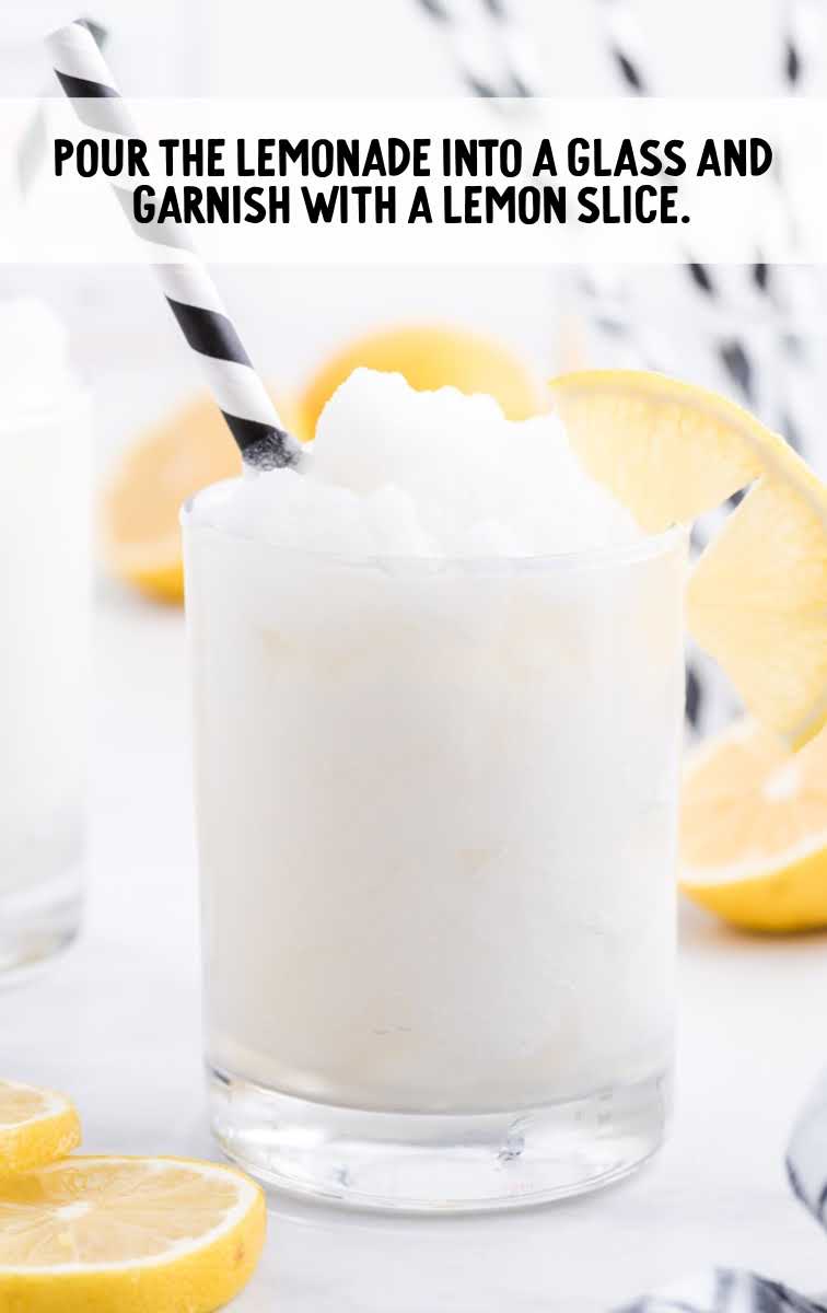 alcoholic frozen lemonade process shot of lemonade poured into glass and garnished with a lemon slice