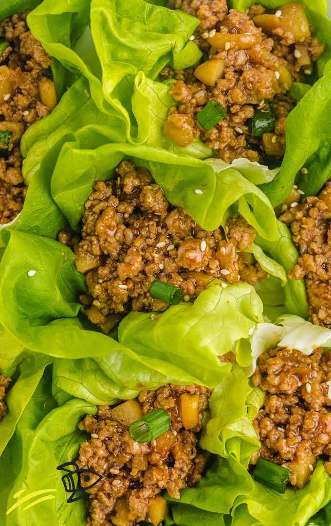 close up shot of Asian chicken lettuce wrap garnished with green onions