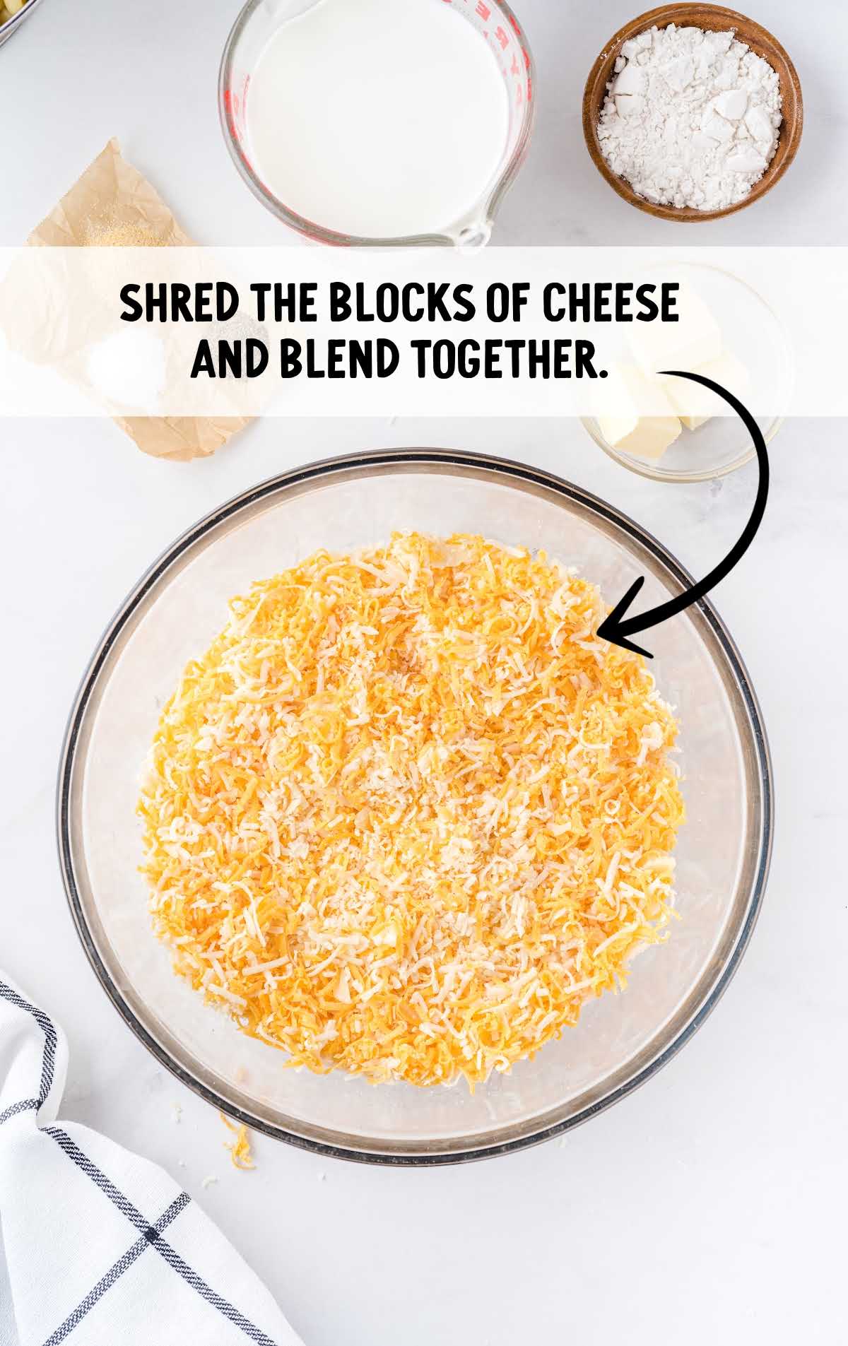 shredded blocks of cheese combined in a bowl